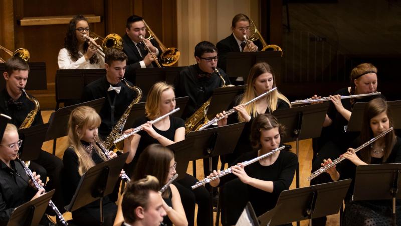 Wind Ensemble students perform onstage during a concert.