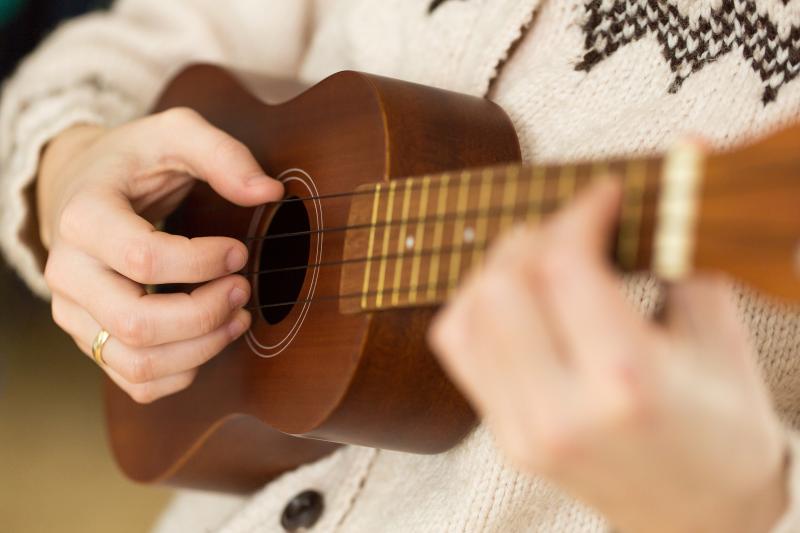 Person playing ukulele