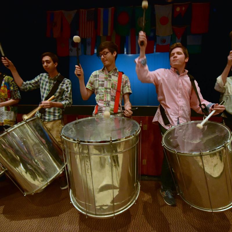 4 men playing drums