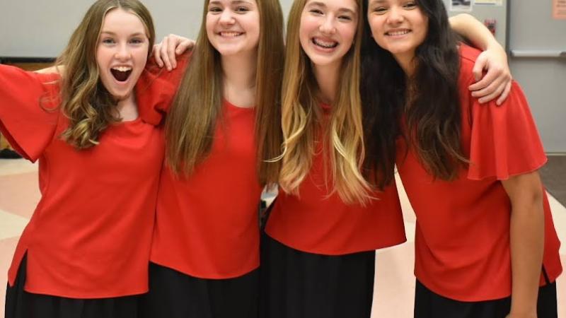 4 smiling singers backstage