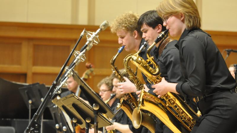 3 saxophonists performing on chapel stage